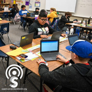 Students working on laptops in a classroom