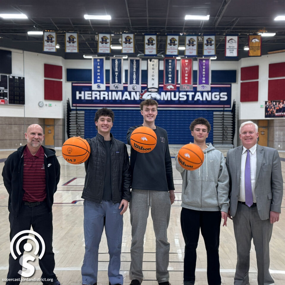 Superintendent with the HHS basketball coach and some players.