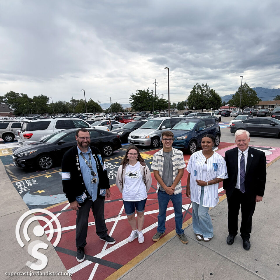 Superintendent with students who panited the lot"