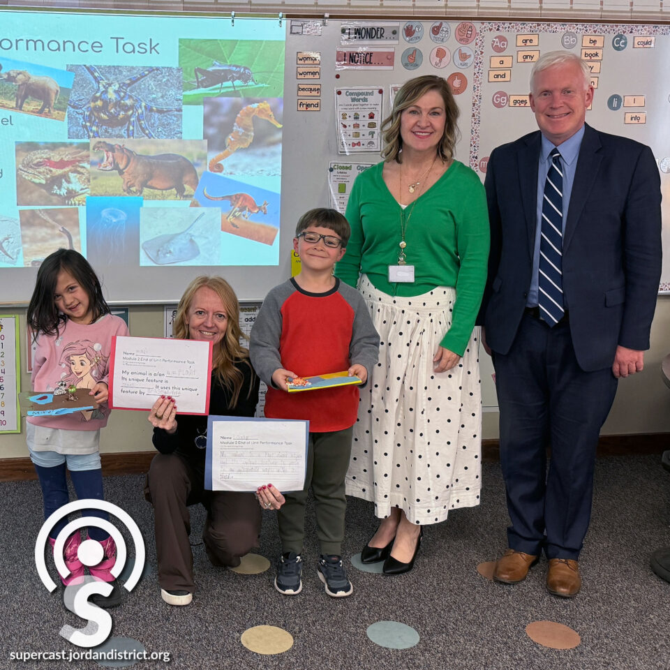 Superintendent with language arts teachers and students