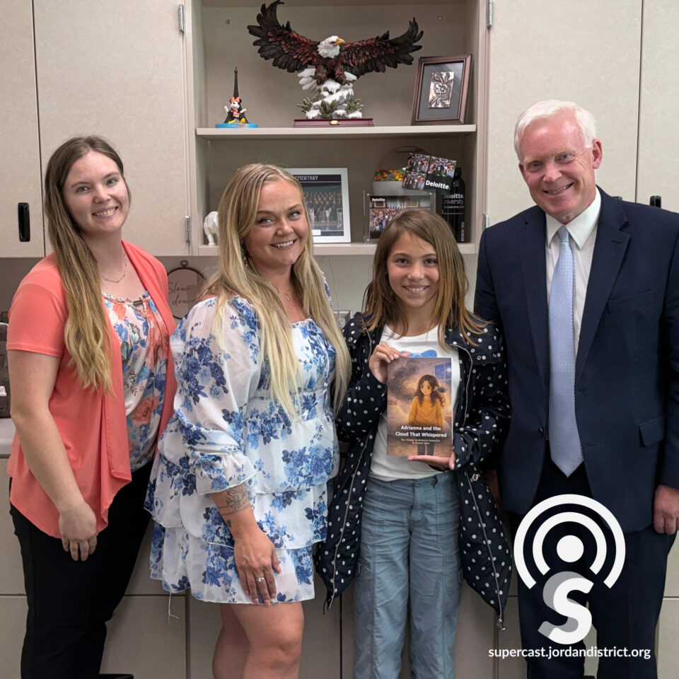 Superintendent with a student, parent, and a teacher